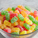 A glass bowl filled with colorful Kervan Sour Gummy Bears.