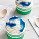 A white plate with two cups of Kervan Gummy Sharks on top of blue and white ice cream.