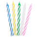 A box of Sterno birthday candles in yellow, blue, pink, and green with white stripes.