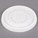 A white plastic lid with a circular pattern.