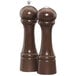 A close-up of two wooden Chef Specialties Windsor Walnut salt and pepper shakers.