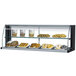 A Turbo Air black top dry display case on a counter with a variety of pastries.