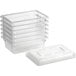 A stack of clear Cambro food storage boxes with lids.