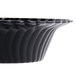A close-up of a black Fineline Flairware plastic bowl with a wavy design.