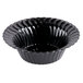 A black Fineline Flairware plastic bowl with wavy edges.
