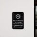 A black and white Thunder Group sign on a wall that says "We are pleased to provide all our guests a smoke-free environment"