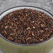 A bowl of brown and black Davidson's Organic Decaf Black Loose Leaf Tea.