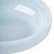 A close-up of a light blue Thunder Group Blue Jade melamine bowl with a white rim.