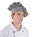 A man wearing a black and white Intedge chef hat.