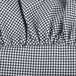 A close-up of black and white houndstooth fabric on a chef hat.