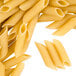 A pile of Regal Penne Rigate pasta on a white background.