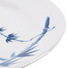 A close up of a white melamine plate with blue bamboo leaves.