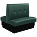 An American Tables & Seating forest green upholstered double booth with button tufted back and black base.