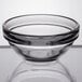 An Arcoroc clear glass bowl with a rim on top.