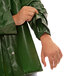 A person wearing a green Tingley Iron Eagle rain jacket.