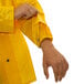 A person wearing a yellow Tingley Iron Eagle rain jacket.