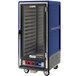 A blue Metro C5 heated holding and proofing cabinet with clear door on wheels.