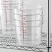 A stack of Cambro clear plastic food storage containers.
