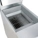A Frymaster natural gas floor fryer with a grate on top.