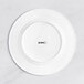 A white Acopa Cordelia porcelain plate with embossed black text on the rim.