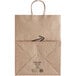 A brown Bagcraft paper shopping bag with handles and "Meals to Go" printing.