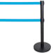 A black Aarco crowd control stanchion with dual blue retractable belts.