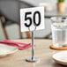Choice 4" Plastic Table Number 50 on a table.