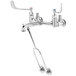 A T&S chrome wall-mounted mop sink faucet with silver wrist action handles.