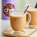 A glass mug of David Rio Orca Spice Chai Tea Latte with a cinnamon stick.