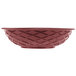 A red round weave basket with a pattern on it.