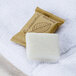 A white Ecossential Naturals bar of soap with a leaf imprint.
