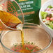 A bowl of salad and a bowl of Colavita Premium Selection Extra Virgin Olive Oil.