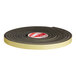 A roll of black and yellow tape with "Regency 16' Gasket for Grease Traps" written on it.