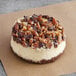 A David's Cookies turtle cheesecake with nuts on top.