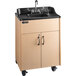 A Premier Maple portable hand sink with a laminate cabinet on wheels.