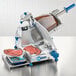 An Edlund compact manual meat slicer with a digital scale weighing meat.