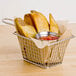 A potato wedge from a Choice Prep French Fry Cutter in a basket with ketchup.