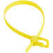 A yellow plastic cable tie with a long tip and metal clip.