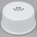 A white plastic lid with the word Tuxton on it covering white china souffle dishes.