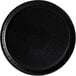 A black round Solut catering tray with a black edge.
