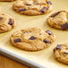 A close-up of a chocolate chip cookie with Enjoy Life Semi-Sweet Vegan Mega Chocolate Chunks on it.