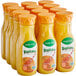A group of Tropicana orange juice bottles with orange plastic caps.