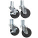 A set of four Manitowoc stainless steel casters with rubber wheels.