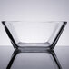 A Libbey square glass bowl on a reflective surface.