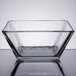 A close-up of a square Libbey glass bowl on a table.