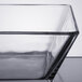 A close up of a clear glass Libbey square bowl with a black rim.