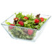 A Libbey square glass bowl filled with salad with strawberries.