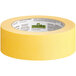 A roll of yellow FrogTape with a white label.