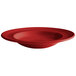 A white background with a red Tuxton Concentrix bowl with a swirl design in the bottom.