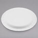 A white Solo medium weight paper plate with a circular rim on a gray surface.